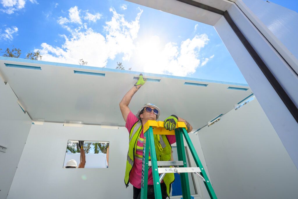 Building hope — worker assembling a Pallet shelter